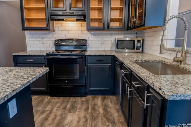 kitchen featuring light stone countertops, sink, blue cabinetry, dark hardwood / wood-style floors, and electric range