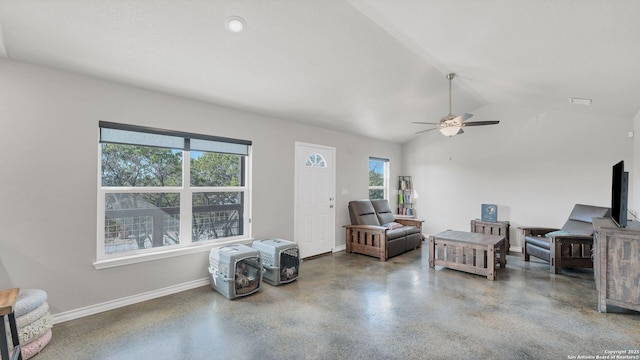 living room with ceiling fan, vaulted ceiling, and a healthy amount of sunlight