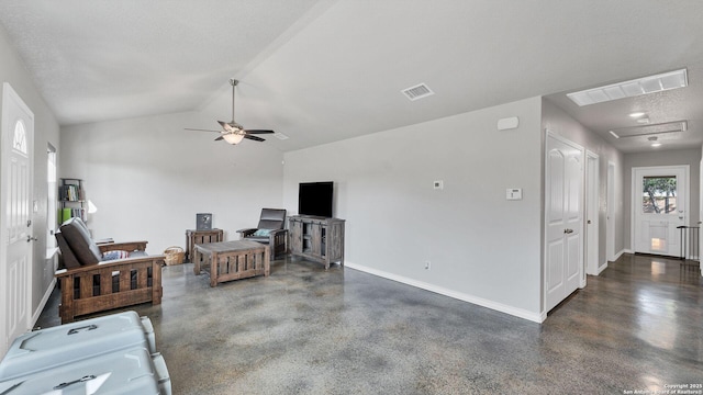 living room featuring ceiling fan, a textured ceiling, and vaulted ceiling