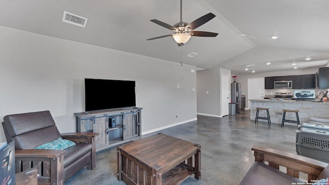 living room featuring ceiling fan and vaulted ceiling