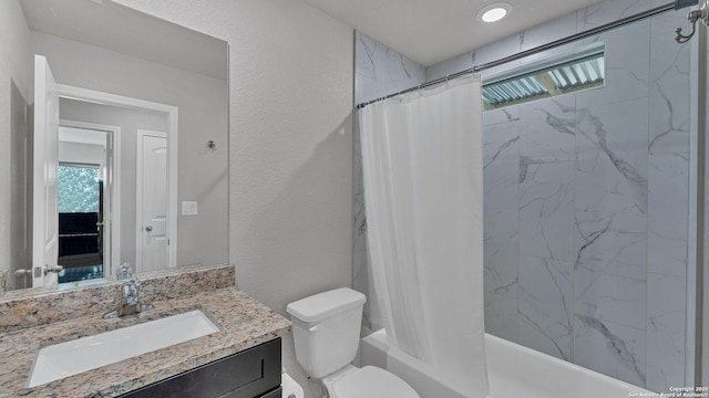 full bathroom featuring toilet, vanity, and shower / bath combo with shower curtain