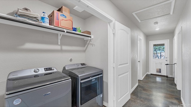 laundry area featuring separate washer and dryer and a textured ceiling