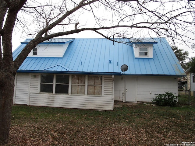 back of property featuring a yard