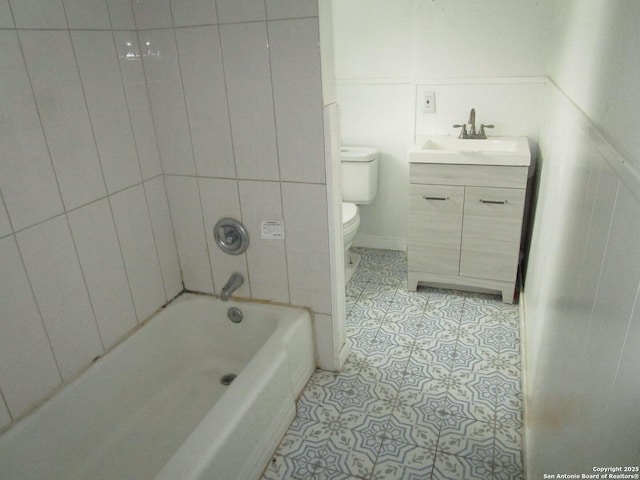 full bathroom with toilet, vanity, tile patterned flooring, and tiled shower / bath