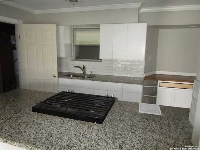 kitchen featuring white cabinets, sink, stone countertops, black gas cooktop, and ornamental molding