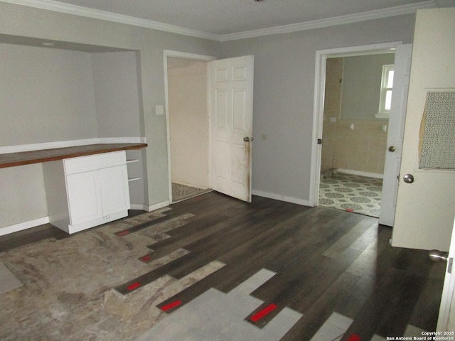 unfurnished room with dark wood-type flooring and ornamental molding