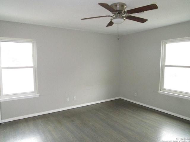 spare room with ceiling fan and dark hardwood / wood-style floors