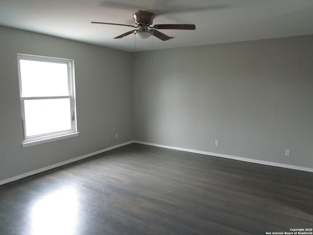 unfurnished room with ceiling fan and dark hardwood / wood-style floors