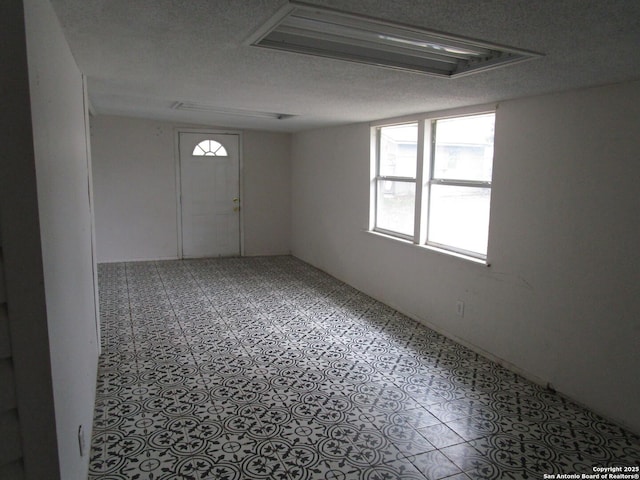 spare room featuring a textured ceiling