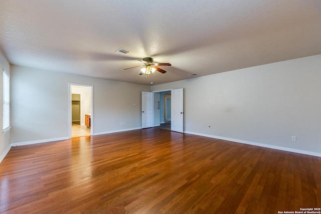 spare room featuring ceiling fan, wood-type flooring, and a textured ceiling