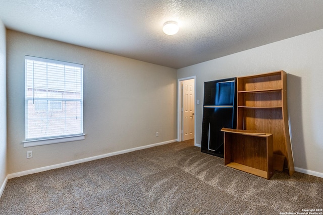 unfurnished bedroom with carpet floors and a textured ceiling