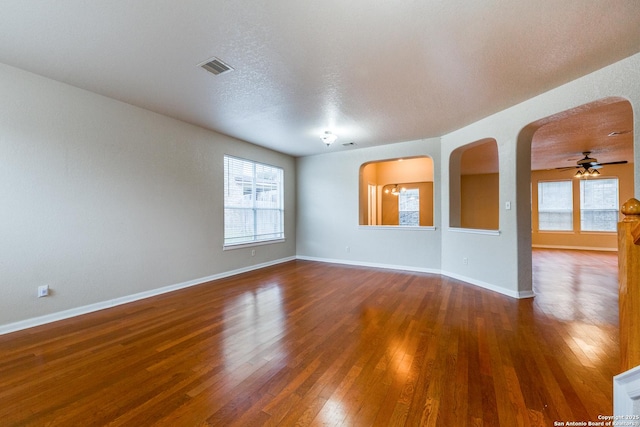 unfurnished room featuring ceiling fan, a textured ceiling, and hardwood / wood-style floors