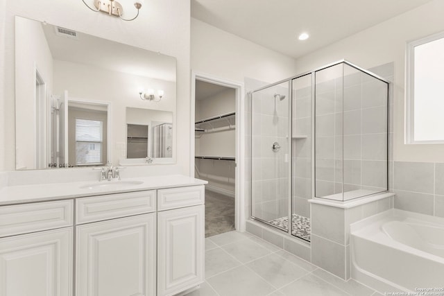 bathroom with plenty of natural light, vanity, shower with separate bathtub, and tile patterned flooring