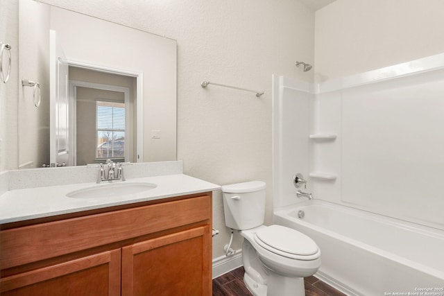 full bathroom featuring toilet, vanity, tub / shower combination, and hardwood / wood-style floors