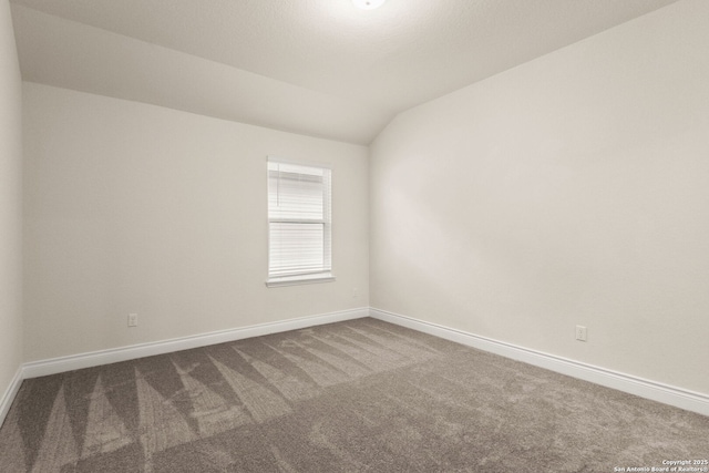 unfurnished room with carpet floors and lofted ceiling