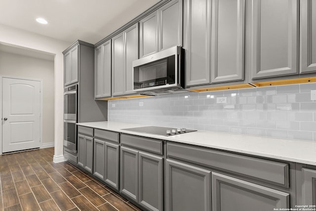 kitchen featuring appliances with stainless steel finishes, gray cabinetry, and tasteful backsplash