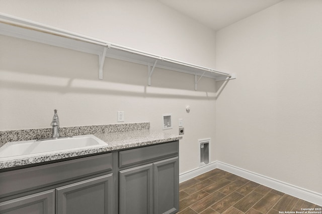 laundry area featuring hookup for a gas dryer, sink, hookup for a washing machine, electric dryer hookup, and cabinets