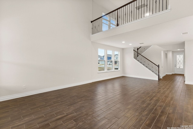 unfurnished living room with a high ceiling