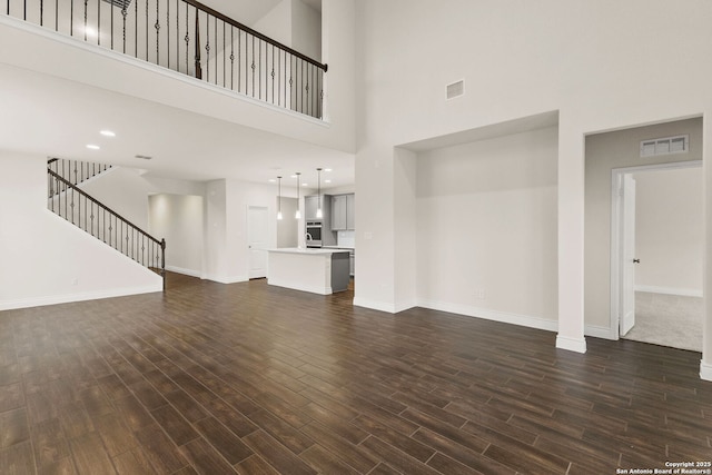 unfurnished living room with a high ceiling