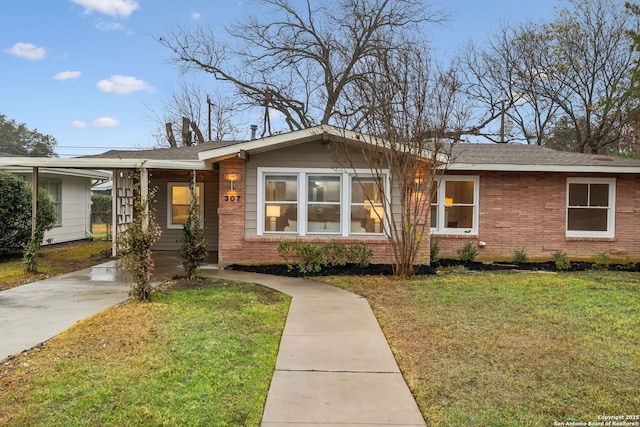 ranch-style home with a front yard and a carport