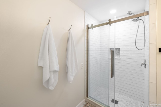 bathroom featuring a shower with shower door