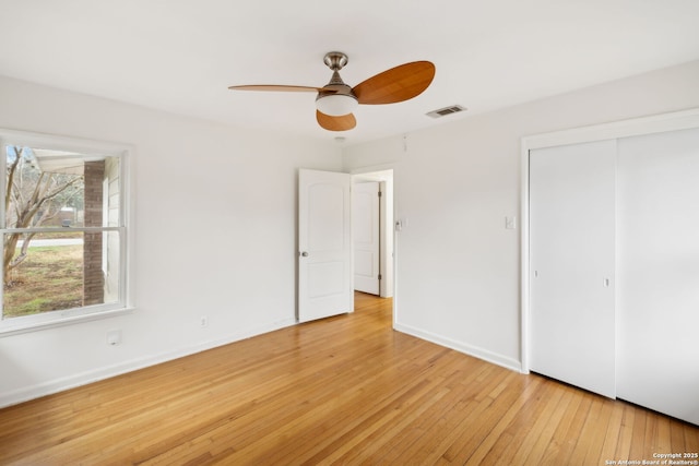 unfurnished bedroom with ceiling fan, light hardwood / wood-style floors, and a closet