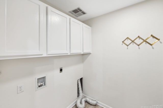 laundry area featuring electric dryer hookup, washer hookup, and cabinets