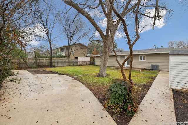 view of yard with cooling unit and a patio