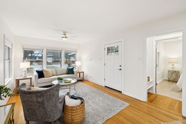 living room with hardwood / wood-style flooring and ceiling fan