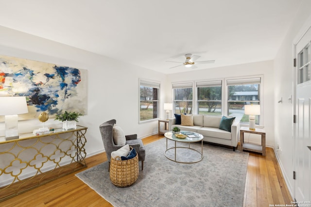 living room with ceiling fan and light hardwood / wood-style flooring