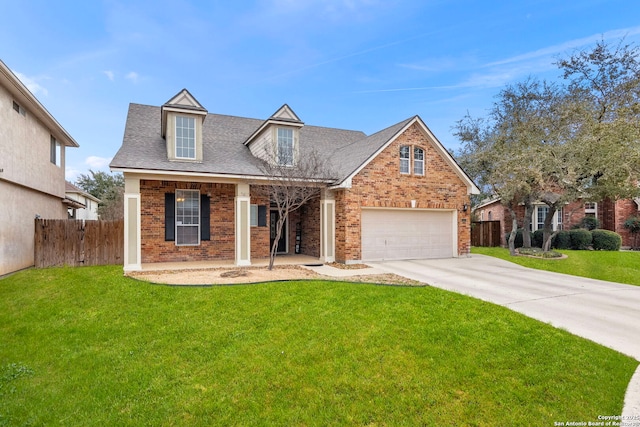 view of front facade featuring fence, a front lawn, concrete driveway, and brick siding