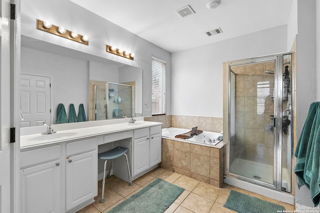 bathroom with a garden tub, visible vents, a sink, and a stall shower