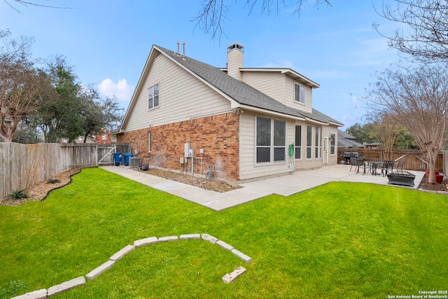 back of property featuring brick siding, a yard, a patio, cooling unit, and a fenced backyard