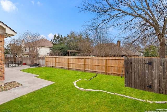 view of yard with an outdoor fire pit, a patio area, and a fenced backyard