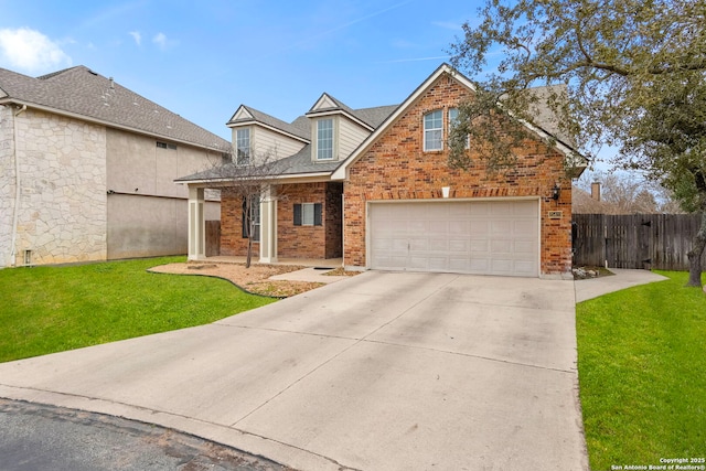 traditional home with concrete driveway, brick siding, a front yard, and fence