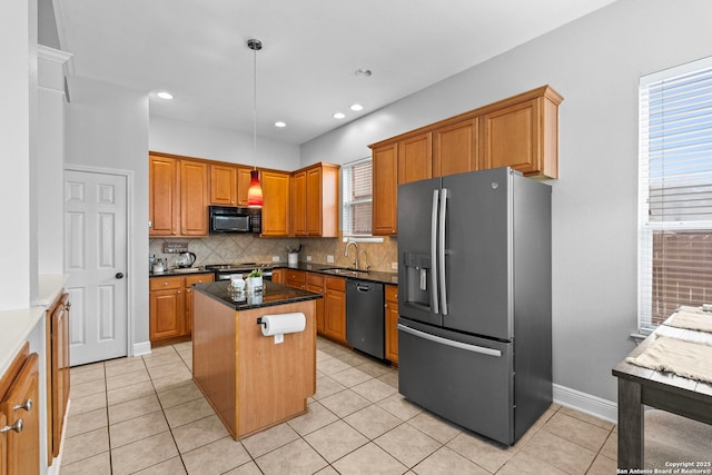 kitchen with pendant lighting, tasteful backsplash, a sink, a kitchen island, and black appliances