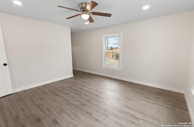 unfurnished room featuring ceiling fan and hardwood / wood-style flooring