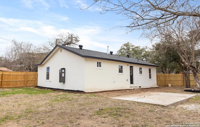 rear view of property with a yard and a patio