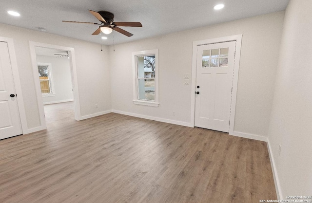 foyer entrance with light wood-type flooring and ceiling fan