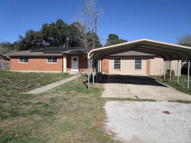 single story home featuring a front lawn and a carport