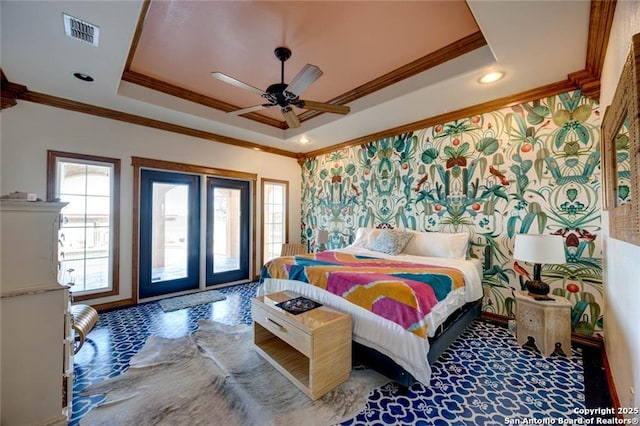 bedroom with ceiling fan, ornamental molding, a raised ceiling, and access to outside