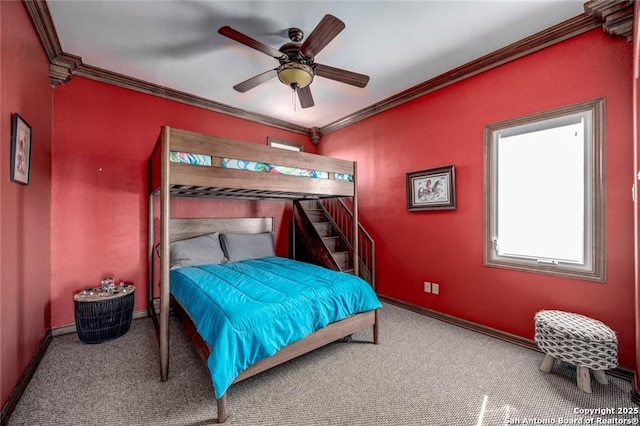 carpeted bedroom with ceiling fan and crown molding