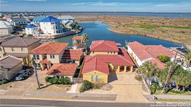 birds eye view of property with a water view and a residential view