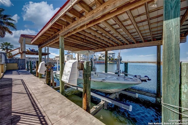 view of dock featuring a water view and boat lift