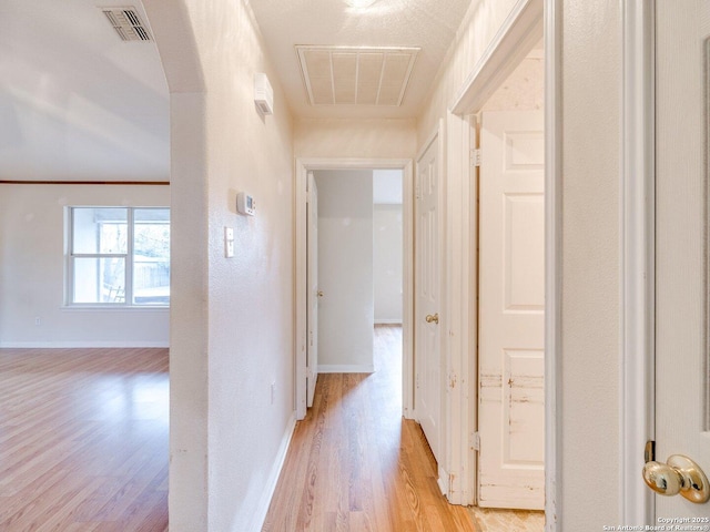 hallway with light hardwood / wood-style flooring