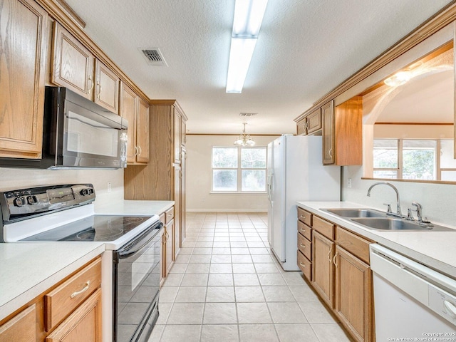 kitchen with a notable chandelier, white appliances, light tile patterned flooring, hanging light fixtures, and sink