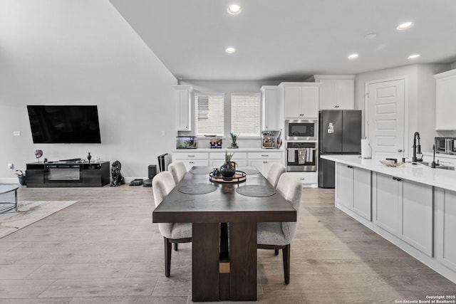 dining space featuring light hardwood / wood-style flooring and sink