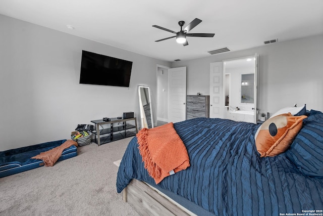 carpeted bedroom featuring ceiling fan and ensuite bath