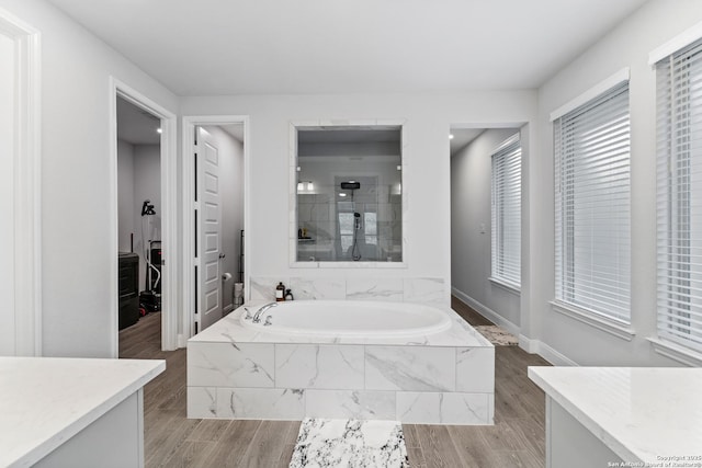 bathroom featuring shower with separate bathtub