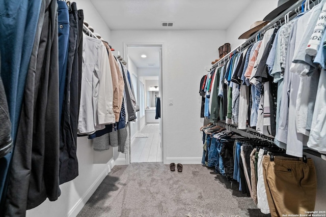 walk in closet featuring carpet